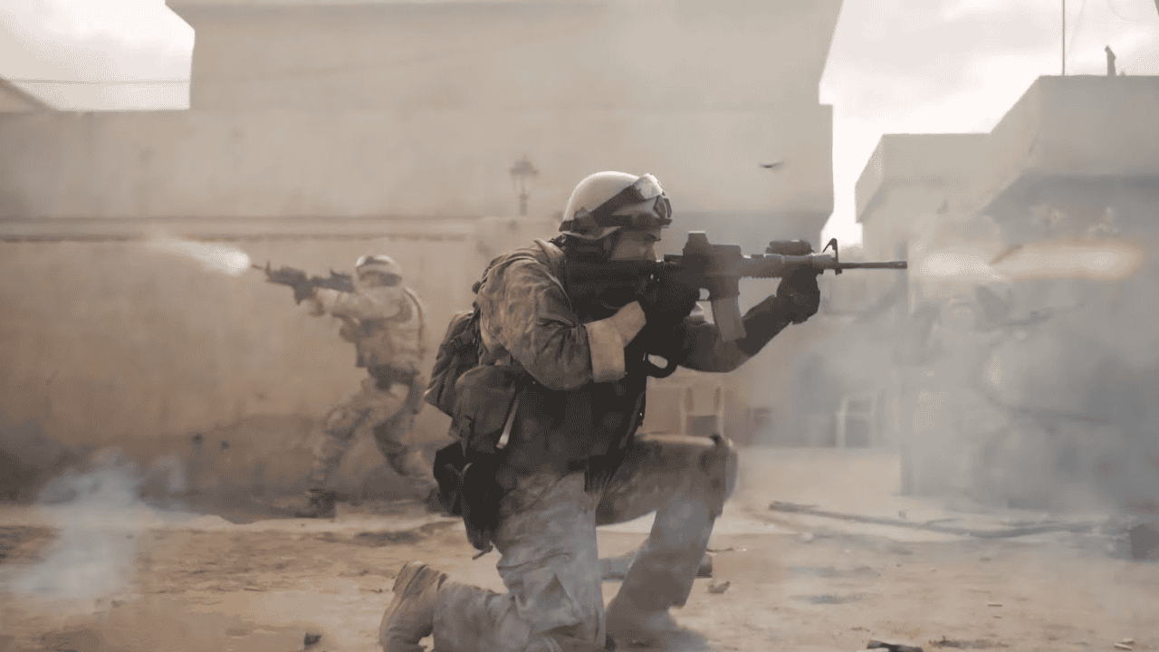Soldiers crouch to deliver covering fire in a shot from Alex Garland's Warfare, starring Will Poulter, Kit Conner, Finn Bennett, Joseph Quinn.